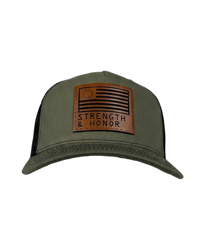 The Alex Jones Store - Front view of olive green Strength & Honor leather patch trucker hat with Betsy Ross flag and slogan on black mesh
