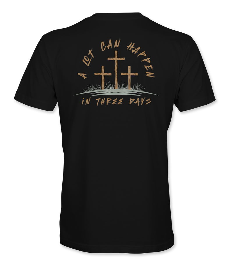 The Alex Jones Store - Back view of black 'A Lot Can Happen In Three Days' t-shirt with three crosses on a hill and tan script Easter design