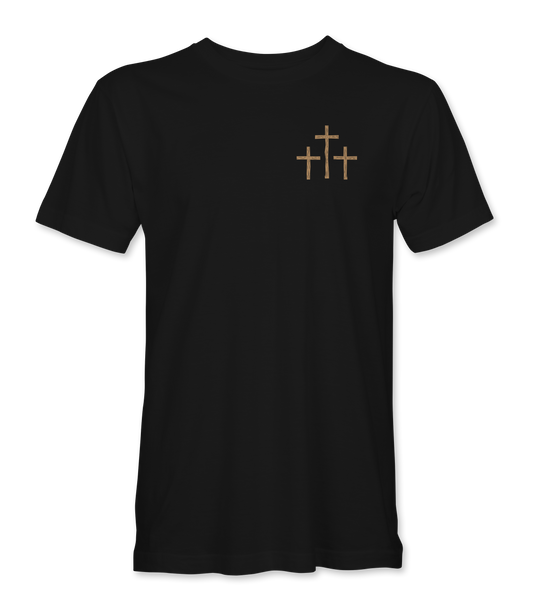 The Alex Jones Store - Front of black 'A Lot Can Happen In Three Days' t-shirt with small tan three-crosses graphic at left chest
