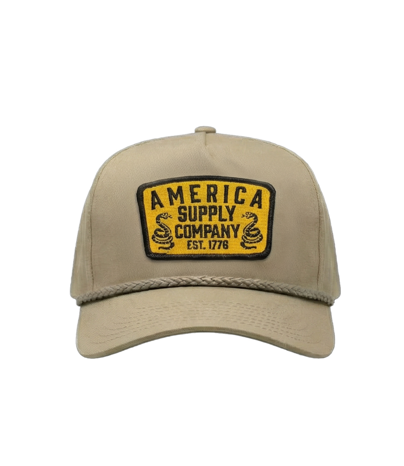 The Alex Jones Store - Front view of tan rope-brim cap with yellow America Supply Company Est. 1776 patch featuring twin rattlesnake design