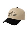 The Alex Jones Store - Side view of tan crown black brim Alex Jones Live Signature Trucker Hat with signature-style embroidered logo