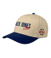 The Alex Jones Store - Side view of tan and navy Alex Jones Live Tan Embroidered Hat with 'ALEX JONES Live' front logo and 'We're Still Here' side stamp