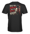 The Alex Jones Store - Back of black 'Nice Try Globalists But I'm Still Here' tee with bold red and white text over Alex Jones flag illustration