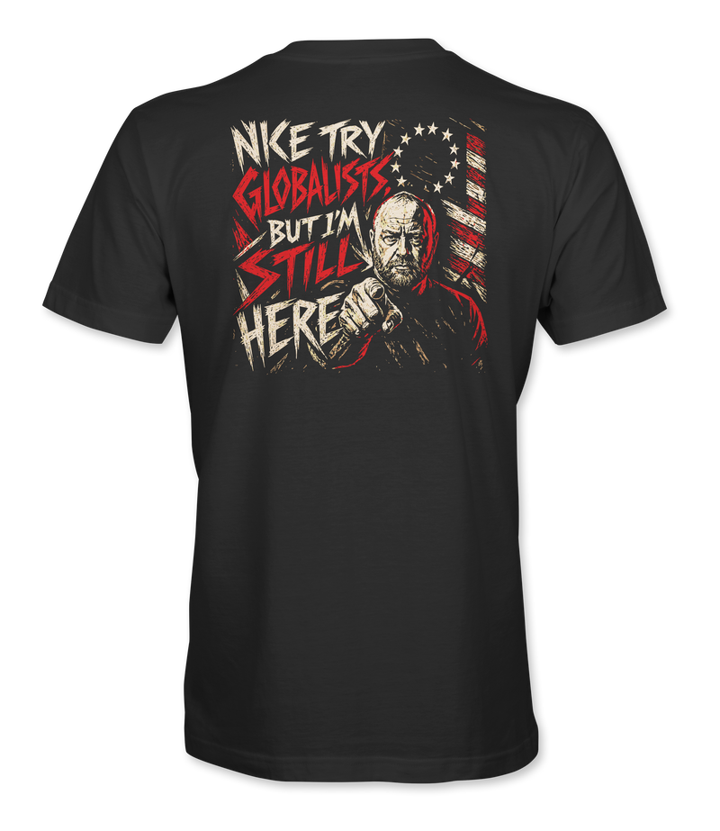 The Alex Jones Store - Back of black 'Nice Try Globalists But I'm Still Here' tee with bold red and white text over Alex Jones flag illustration