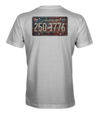 The Alex Jones Store - Back of white 'America 250 1775' tee with distressed vintage license plate graphic over American flag background