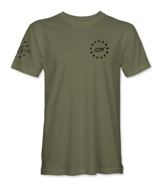 The Alex Jones Store - Front of olive green 1776 America Supply Co t-shirt with small left-chest Betsy Ross ring and 1776 numerals