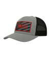 The Alex Jones Store - Angled side view of grey America Supply Co trucker hat with red-bordered American flag patch and black mesh back
