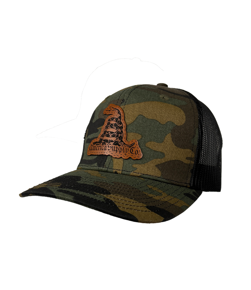 The Alex Jones Store - Angled side view of camo America Supply Co Gadsden leather patch trucker hat with rattlesnake patch and black mesh back