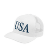 The Alex Jones Store - White 'USA' Premium Trucker Hat with navy serif USA logo, side-angle view showing mesh back and curved bill