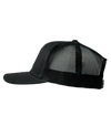 The Alex Jones Store - Obedience To God Circle Star Leather Patch Hat — Left side view of black mesh-back trucker hat with leather patch design partially visible
