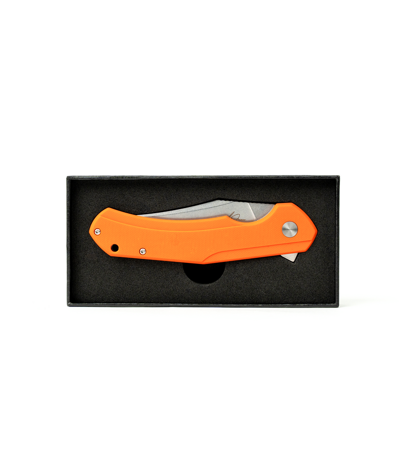 The Alex Jones Store - Alex Jones Burnt Orange folding blade in black foam-lined gift box, orange G10 handle visible in closed carry position