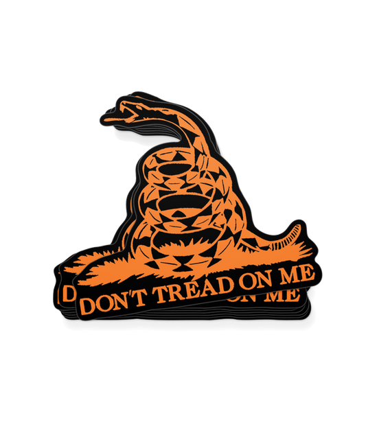 The Alex Jones Store - Black and orange die-cut vinyl decal of coiled Gadsden flag rattlesnake with 'Don't Tread On Me' banner