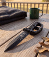 The Alex Jones Store - Life Is Fiery With It's Beauty Trench War Dagger lying on a weathered oak porch table at golden hour