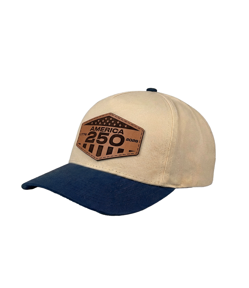 The Alex Jones Store - Side view of cream and navy America 250 patch hat showing leather hexagonal patch with '1776 2026' dates