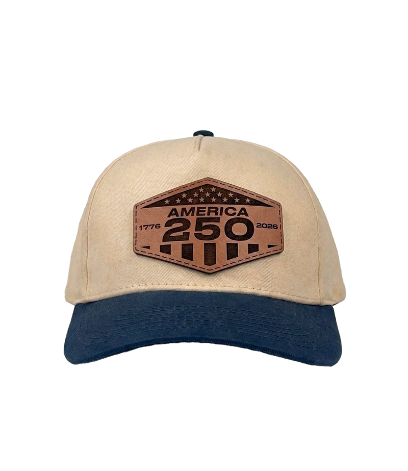 The Alex Jones Store - Cream and navy America 250 patch hat with hexagonal leather '1776-2026 America 250' patch, snapback construction